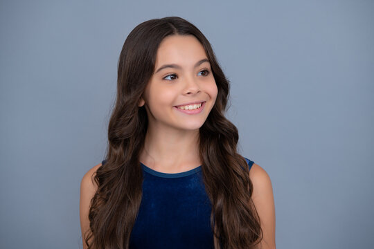 Close-up portrait of girl teen face. Portrait of a cute teen child. Studio shot, isolated background. Happy girl face, positive and smiling emotions.