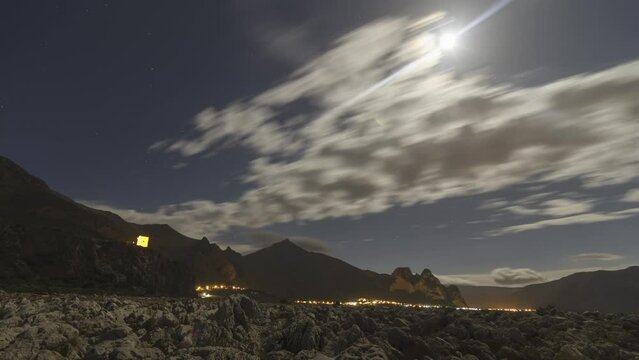 Stone coast, Monte Palatimone and village Castelluzzo with moon and stars time lapse