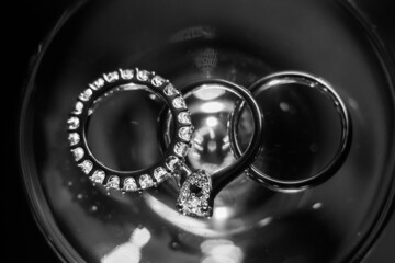 Three wedding rings on the glass surface