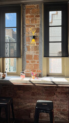 Table with colored pencils and coloring pages over windows and benches on brick wall