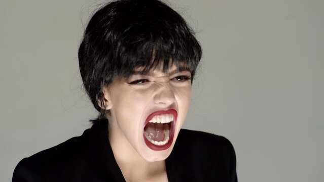 Shouting mouth, screaming face. Young woman frustrated with rage, yelling mad