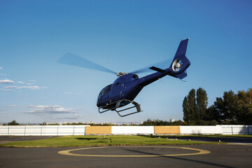 Blue helicopter takes off into the sky