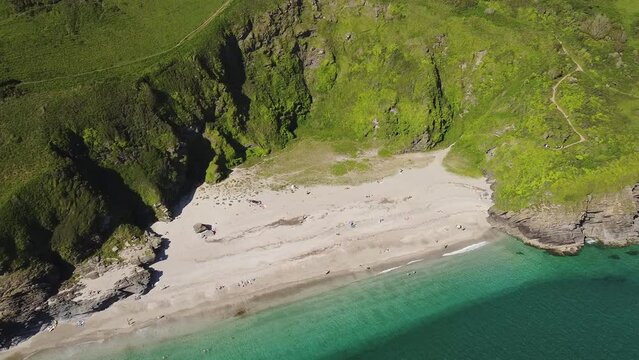 Aerial view of the stunning coastline and beach at Lantic Bay. Crystal clear turquoise sea water in Cornwall, England.