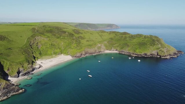 Aerial view of the stunning coastline and beach at Lantic Bay. Crystal clear turquoise sea water in Cornwall, England.
