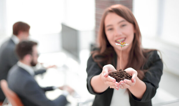 female environmentalist showing fresh sprout