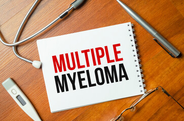 multiple myeloma words on notebook and stethoscope on wooden background