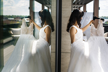 The bride and bridesmaid with wedding dress - obrazy, fototapety, plakaty