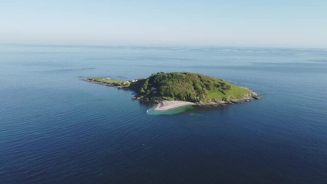 Aerial drone. Crystal clear turquoise water at St Georges Island near Looe, picturesque seaside village. Cornwall, Southwest England, United Kingdom.