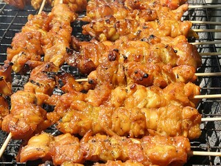 close up chicken grilling on stove