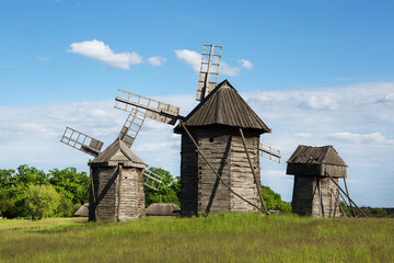 Wooden windmills on the field. Ukraine.
