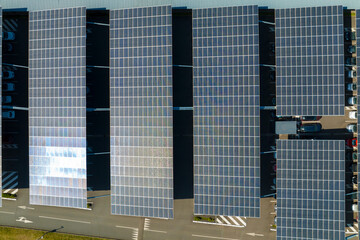 Aerial view of solar panels installed as shade roof over parking lot with parked cars for effective...