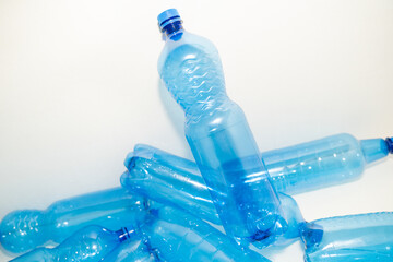 Blue plastic PET bottle in close up on white background.