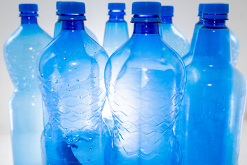 Blue plastic PET bottle in close up on white background.