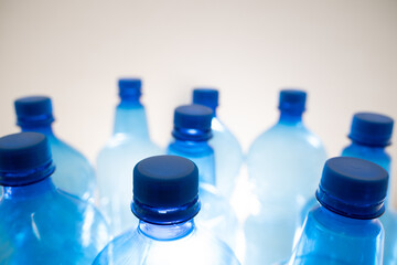 Blue plastic PET bottle in close up on white background.