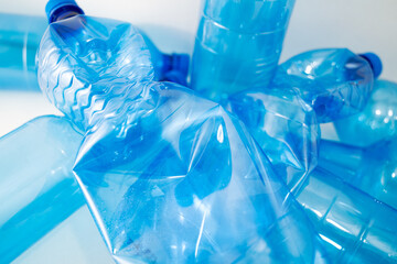 Blue plastic PET bottle in close up on white background. Focus on details