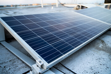 Solar panels located on the roof of the block. Green energy in modern city.