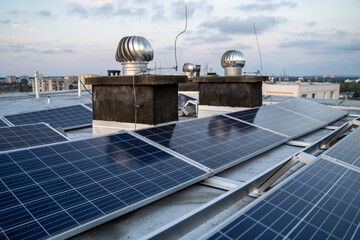 Solar panels located on the roof of the block. Green energy in modern city.
