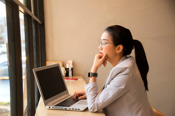 Happy businesswoman using laptop in the office
