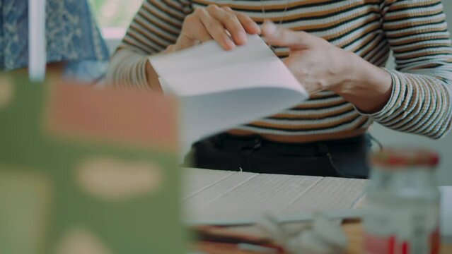 Person at school cutting paper