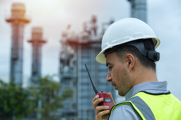 worker talking on the radio communication. industrial engineer in Oil factory. Engineer wearing PPE...