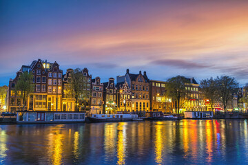Amsterdam Netherlands, sunset city skyline of Dutch house at canal waterfront