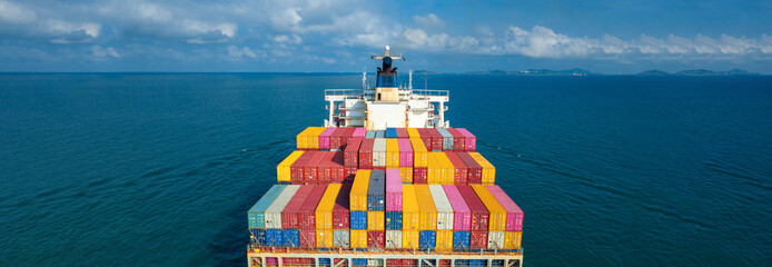 Stern of large cargo ship import export container box on the ocean sea on blue sky back ground...
