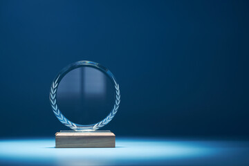 crystal trophy against blue background with copy space