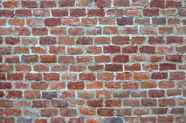 Old shabby red brick wall background. 