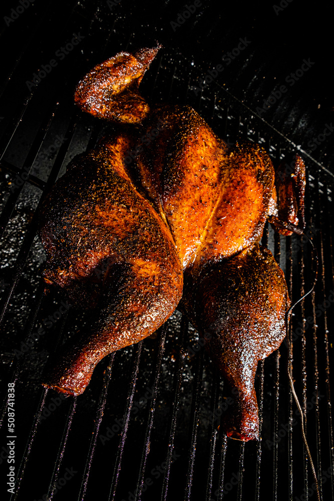 Sticker whole grilled chicken on the grill