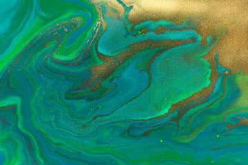 Fototapeta na wymiar Gold spots texture on flow dark blue and green paints abstract background