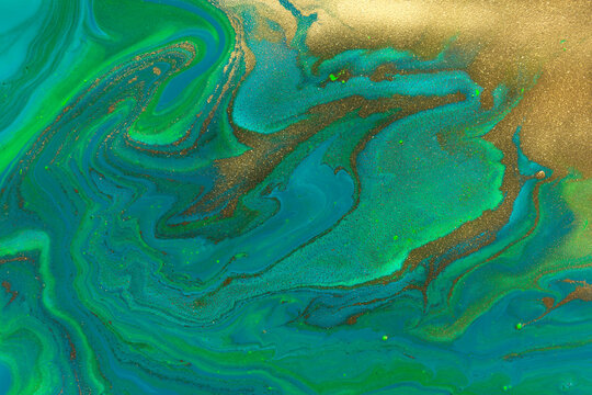 Gold spots texture on flow dark blue and green paints abstract background