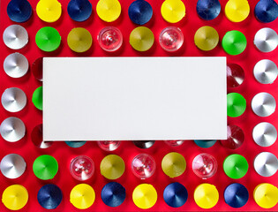 The chips are round in shape and different colors on a red background, the upper angle.