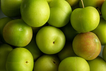 Full screen Stacked Fresh Green Plum (Japanese apricot) background