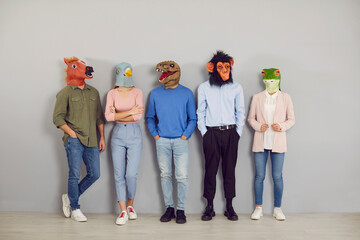 Funny half people half animals waiting by office wall together. Group portrait company workers,...