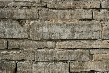 Stone wall made of natural processed stone, background and texture for wallpaper. Wall of an old house