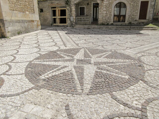 Floor of cobblestones with drawn the wind rose. Travel to Abruzzo Italy