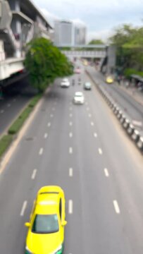 Blurred vertical video of road in Bangkok, Thailand with good traffic
