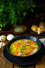 Hearty rustic pea soup with bacon and sausage