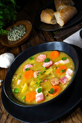 Hearty rustic pea soup with bacon and sausage