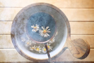 Fototapeta na wymiar phytotherapy, sauna, daisies in a bowl accessories daisy herbs