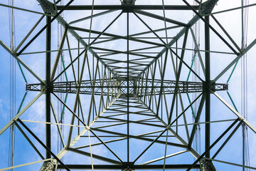 Obraz premium Electricity pylon photographed from below. Extreme low angle view.