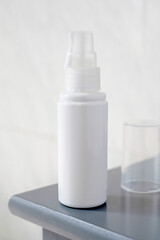 Pure white plastic cosmetic skin care bottle beauty product on bath table, lifestyle product photo