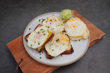 Avocado fried egg sandwich with bread on wooden floor home made