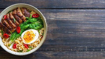 Ramen soup with duck, noodles, cabbage, pepper and egg. Asian food.