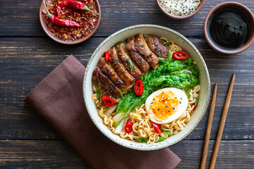 Ramen soup with duck, noodles, cabbage, pepper and egg. Asian food.