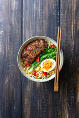 Ramen soup with duck, noodles, cabbage, pepper and egg. Asian food.