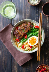 Ramen soup with duck, noodles, cabbage, pepper and egg. Asian food.