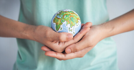 Woman holding earth in hands, Energy saving concept.