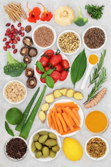 Healthy vegan food collection to boost the immune system, vegetables, fruit, medicinal herbs, spice. Foods high in antioxidants, anthocyanins, fibre, vitamins and minerals. Natural healthcare concept.