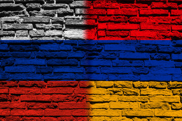 Background with the flag of Russia and Armenia on a brick wall